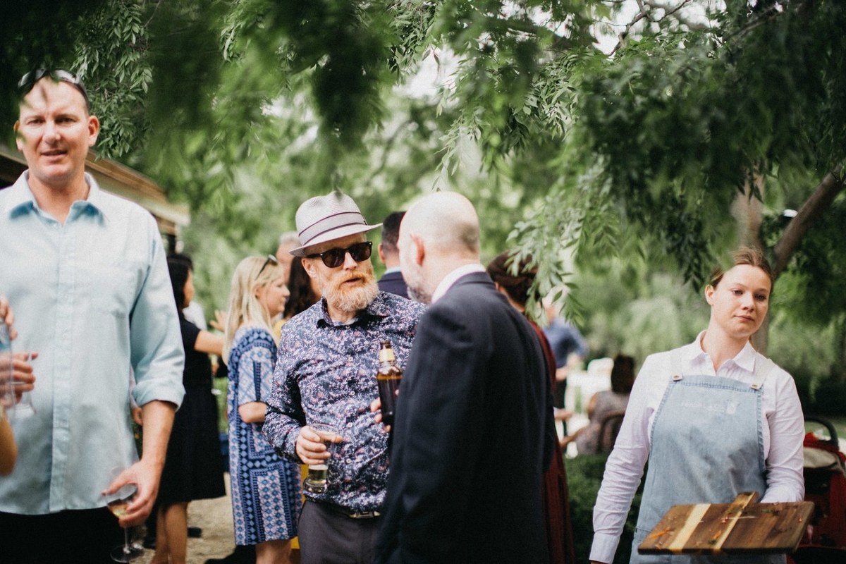 Wedding guests at Redleaf Wollombi — Joshua Mikhaiel, documentary wedding photographer Guests greet one another in the garden before the reception. Photograph by documentary wedding photographer Joshua Mikhaiel.