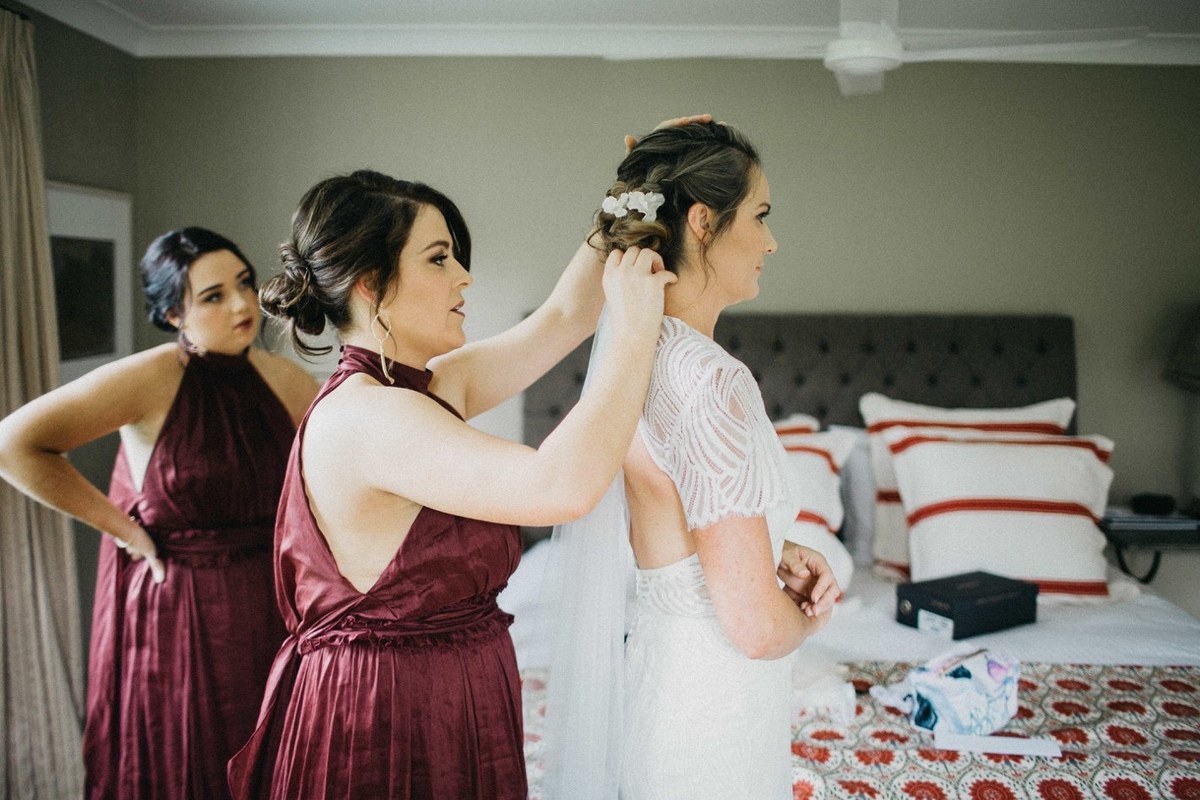 Wedding guests celebrating at Redleaf Wollombi — Joshua Mikhaiel, documentary wedding photographer Two guests lift the bride playfully in the garden. Photograph by documentary wedding photographer Joshua Mikhaiel.
