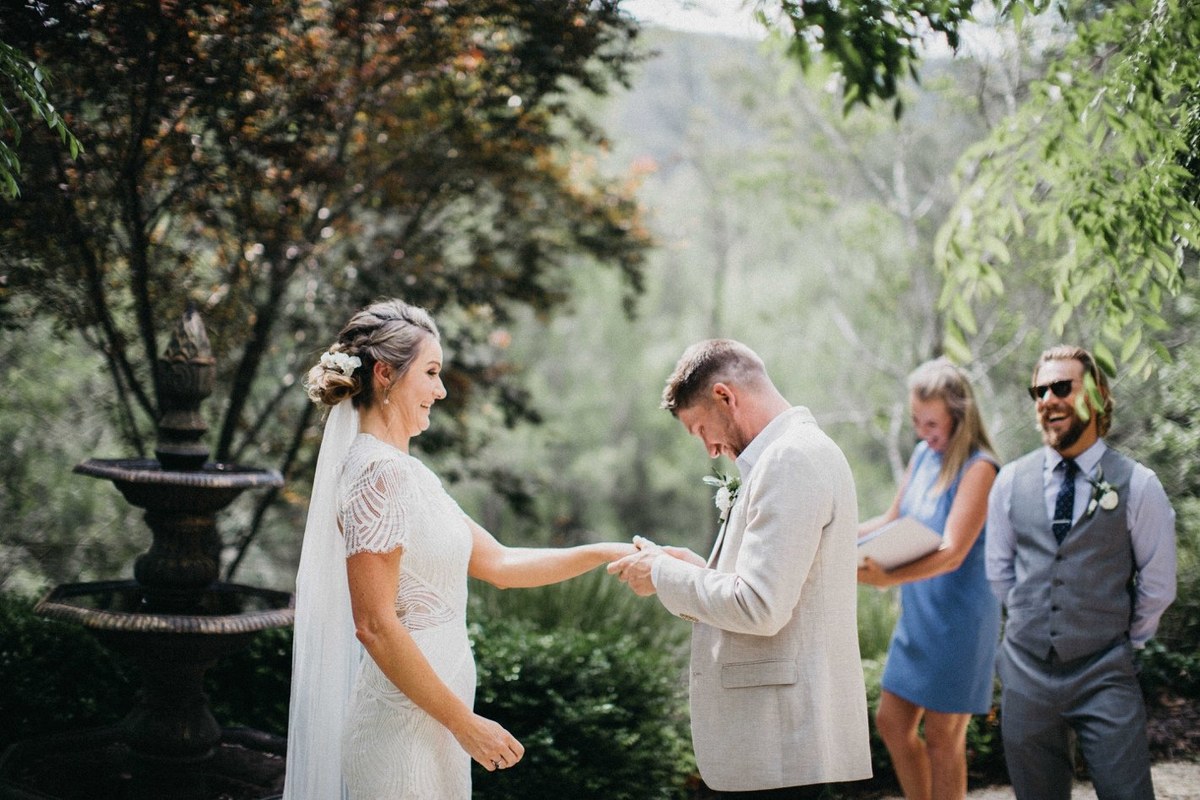 Wedding vows at Redleaf Wollombi — Joshua Mikhaiel, documentary wedding photographer The bride and groom hold hands as the officiant leads the ceremony. Photograph by documentary wedding photographer Joshua Mikhaiel.
