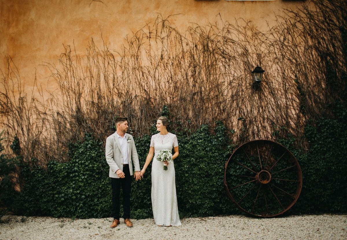 Couple portrait at Redleaf Wollombi — Joshua Mikhaiel, documentary wedding photographer The bride and groom pose beneath a tree in the golden grass. Photograph by documentary wedding photographer Joshua Mikhaiel.