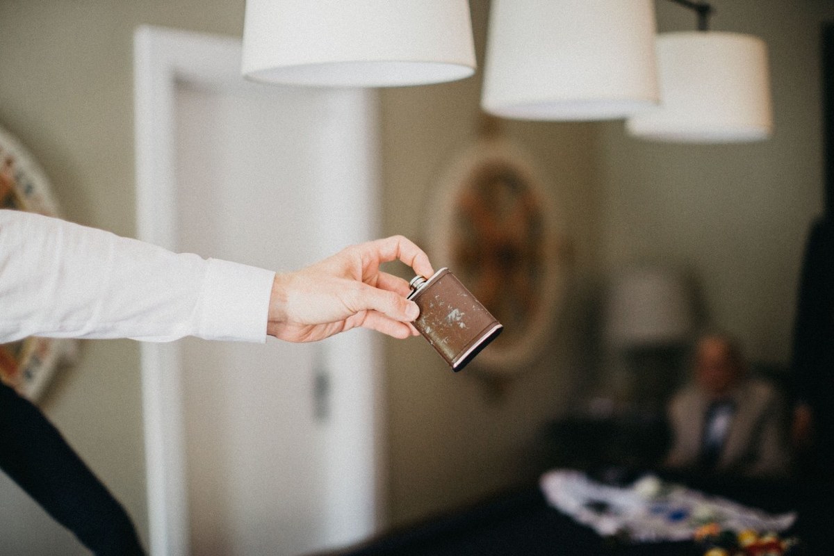 Groom’s boutonniere at Redleaf Wollombi — Joshua Mikhaiel, documentary wedding photographer A man pins a boutonniere onto the groom’s jacket. Photograph by documentary wedding photographer Joshua Mikhaiel.