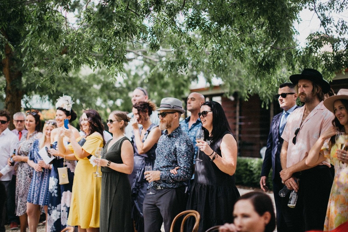 Guests at the Redleaf Wollombi ceremony — Joshua Mikhaiel, documentary wedding photographer Guests sit among the trees as the outdoor ceremony begins. Photograph by documentary wedding photographer Joshua Mikhaiel.
