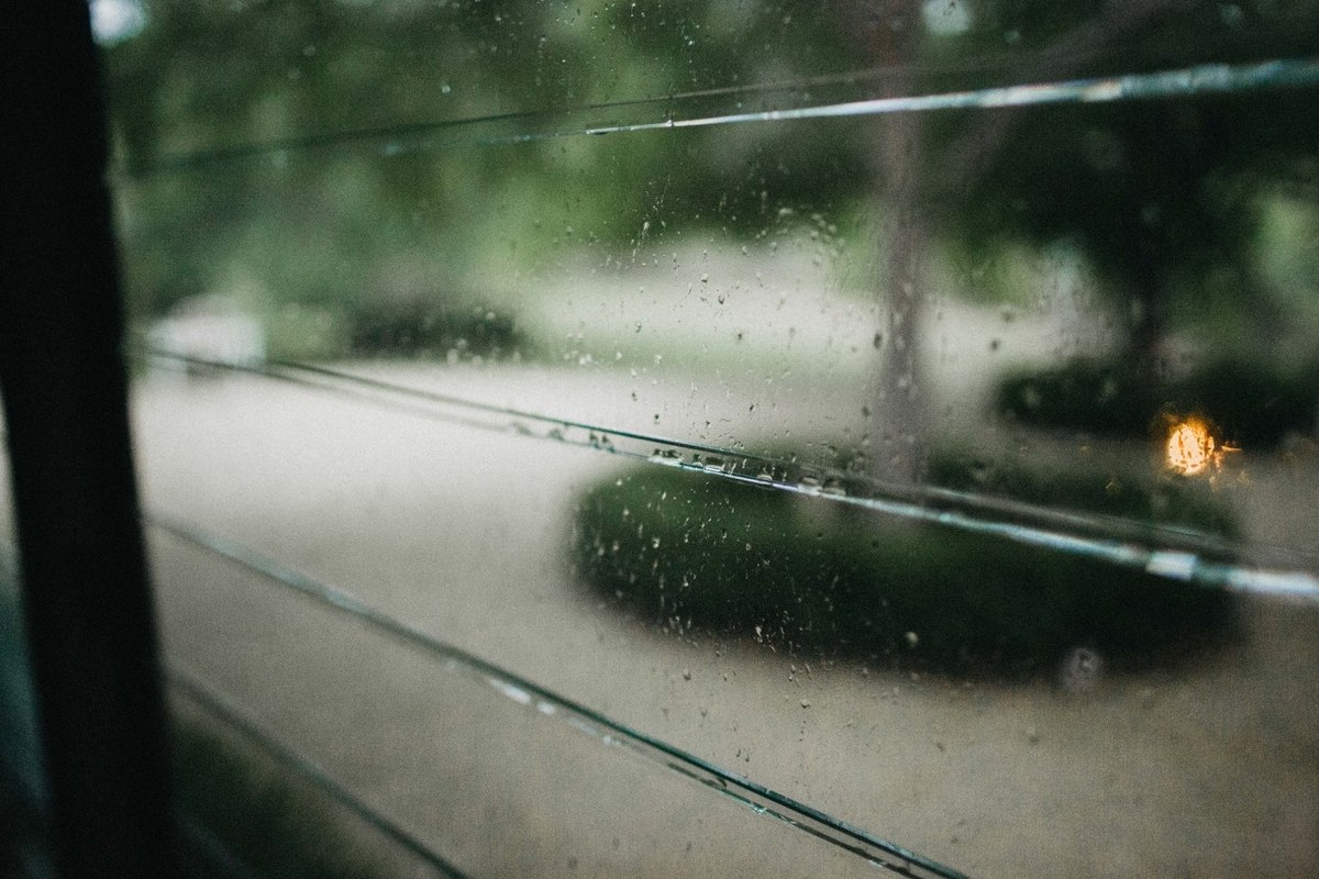 Rain at Redleaf Wollombi — Joshua Mikhaiel, documentary wedding photographer Rain falls across the garden as warm lights glow in the distance. Photograph by documentary wedding photographer Joshua Mikhaiel.