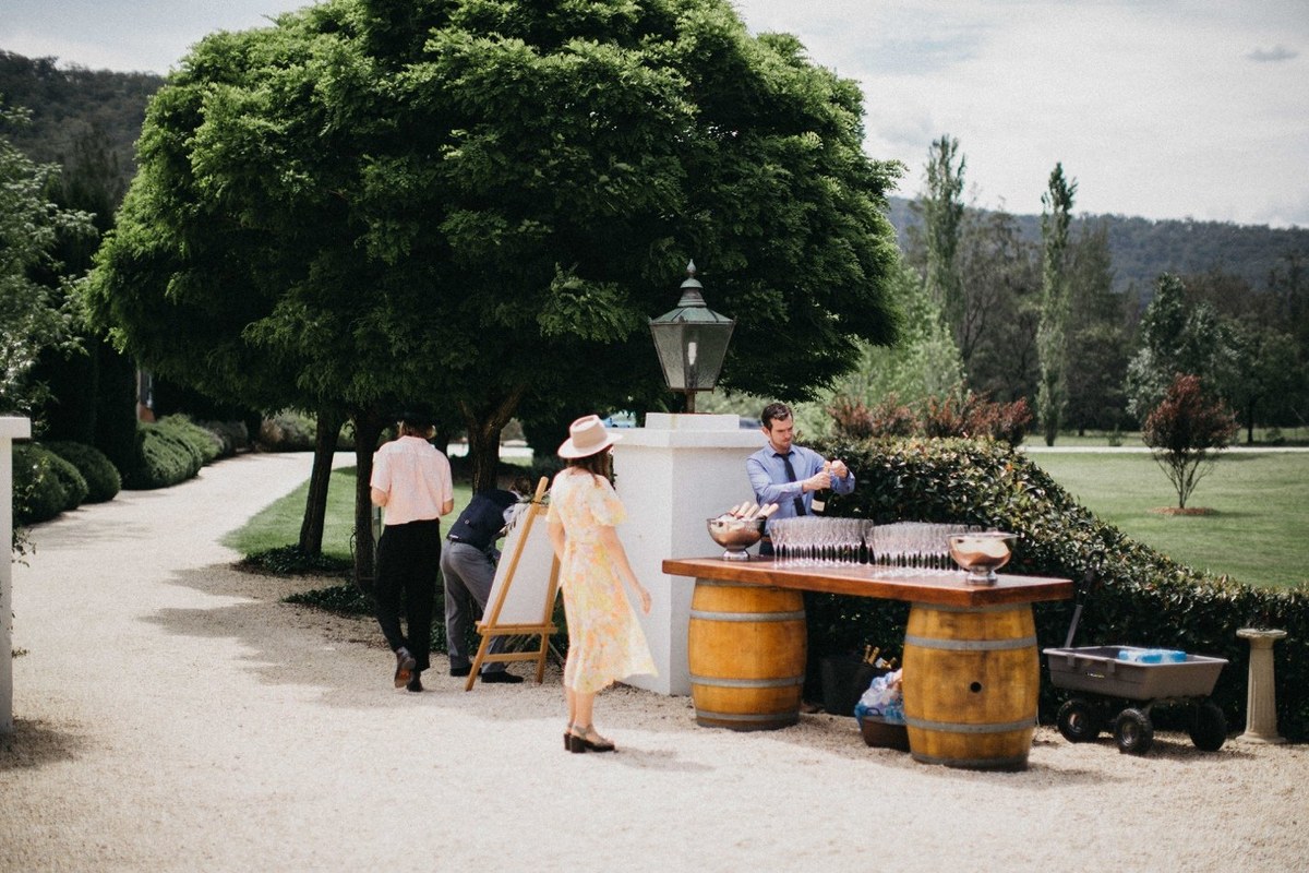 Wedding guests at Redleaf Wollombi — Joshua Mikhaiel, documentary wedding photographer Wedding guests mingle outside the homestead before the ceremony. Photograph by documentary wedding photographer Joshua Mikhaiel.