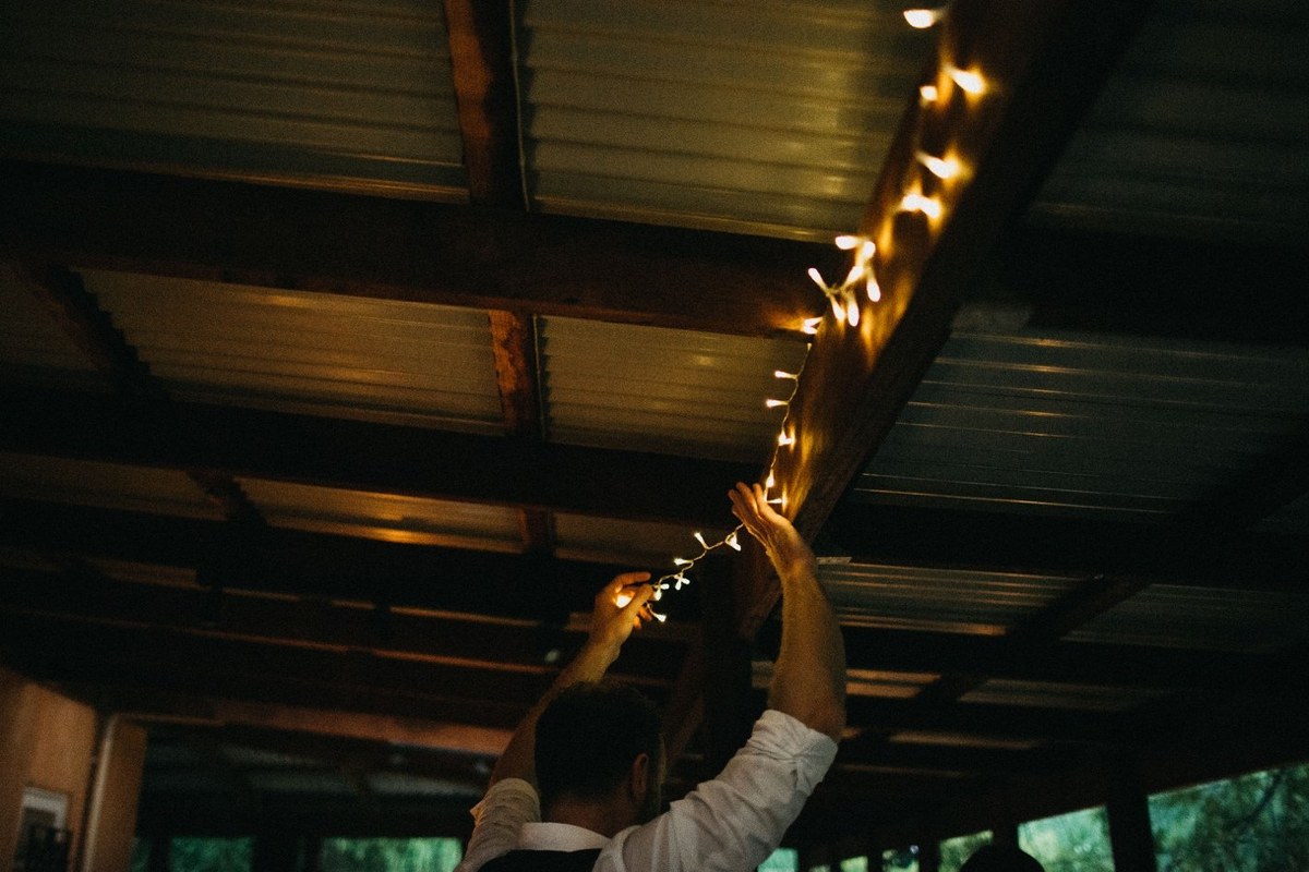 Reception at Redleaf Wollombi — Joshua Mikhaiel, documentary wedding photographer Guests sit together for dinner in the warmly lit reception room. Photograph by documentary wedding photographer Joshua Mikhaiel.