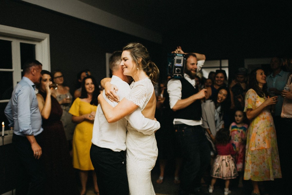 Reception dancing at Redleaf Wollombi — Joshua Mikhaiel, documentary wedding photographer Guests dance around the bride and groom in the warmly lit room. Photograph by documentary wedding photographer Joshua Mikhaiel.