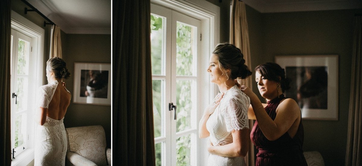 Bride getting ready at Redleaf Wollombi — Joshua Mikhaiel, documentary wedding photographer An attendant helps the bride prepare beside the bedroom window. Photograph by documentary wedding photographer Joshua Mikhaiel.