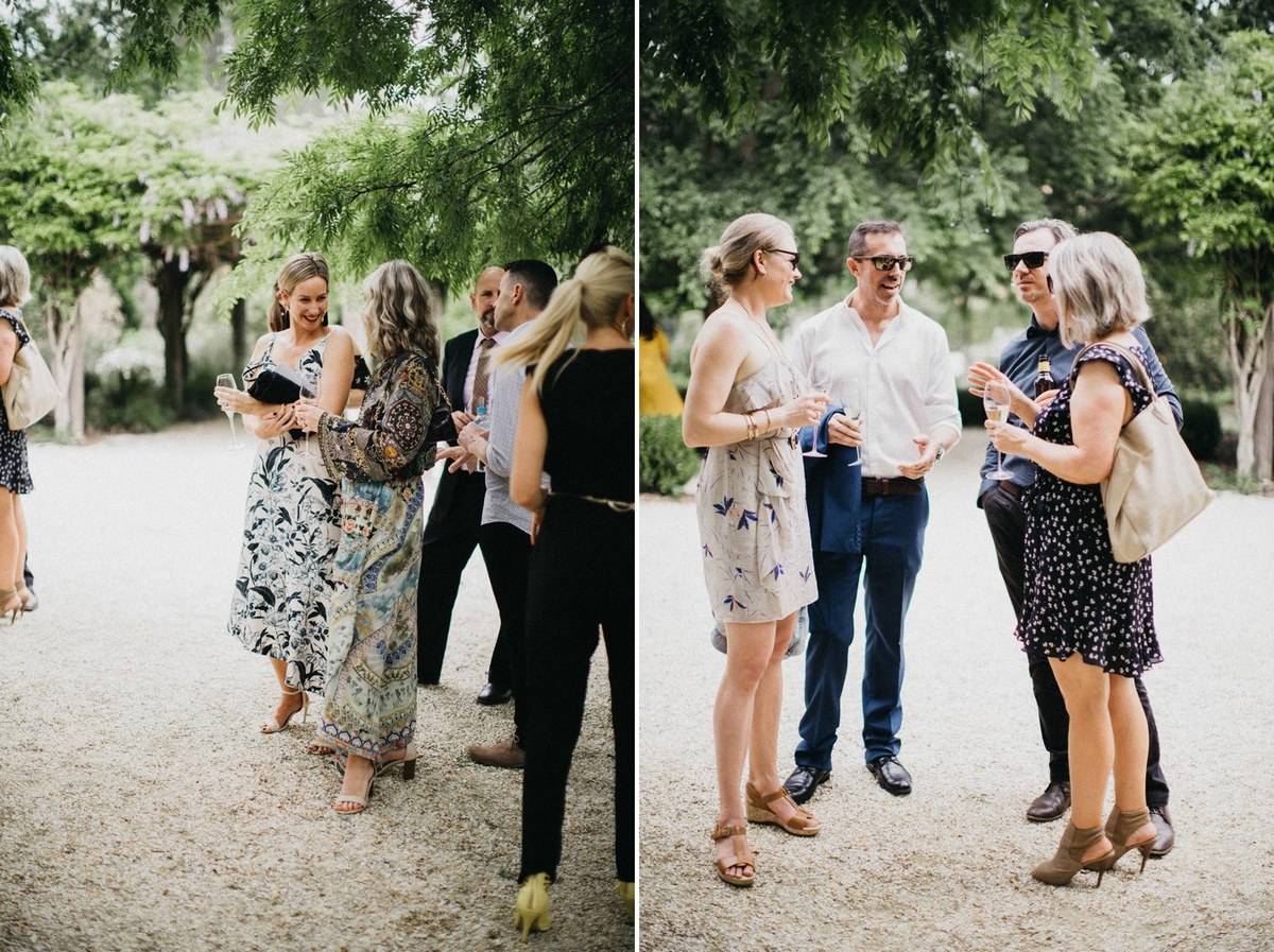 Wedding guests at Redleaf Wollombi — Joshua Mikhaiel, documentary wedding photographer Two guests speak together beneath the trees before the ceremony. Photograph by documentary wedding photographer Joshua Mikhaiel.