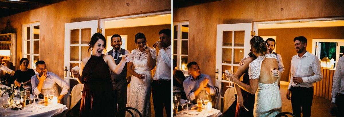 Guests celebrating at Redleaf Wollombi — Joshua Mikhaiel, documentary wedding photographer Guests raise their hands and dance around the tables. Photograph by documentary wedding photographer Joshua Mikhaiel.