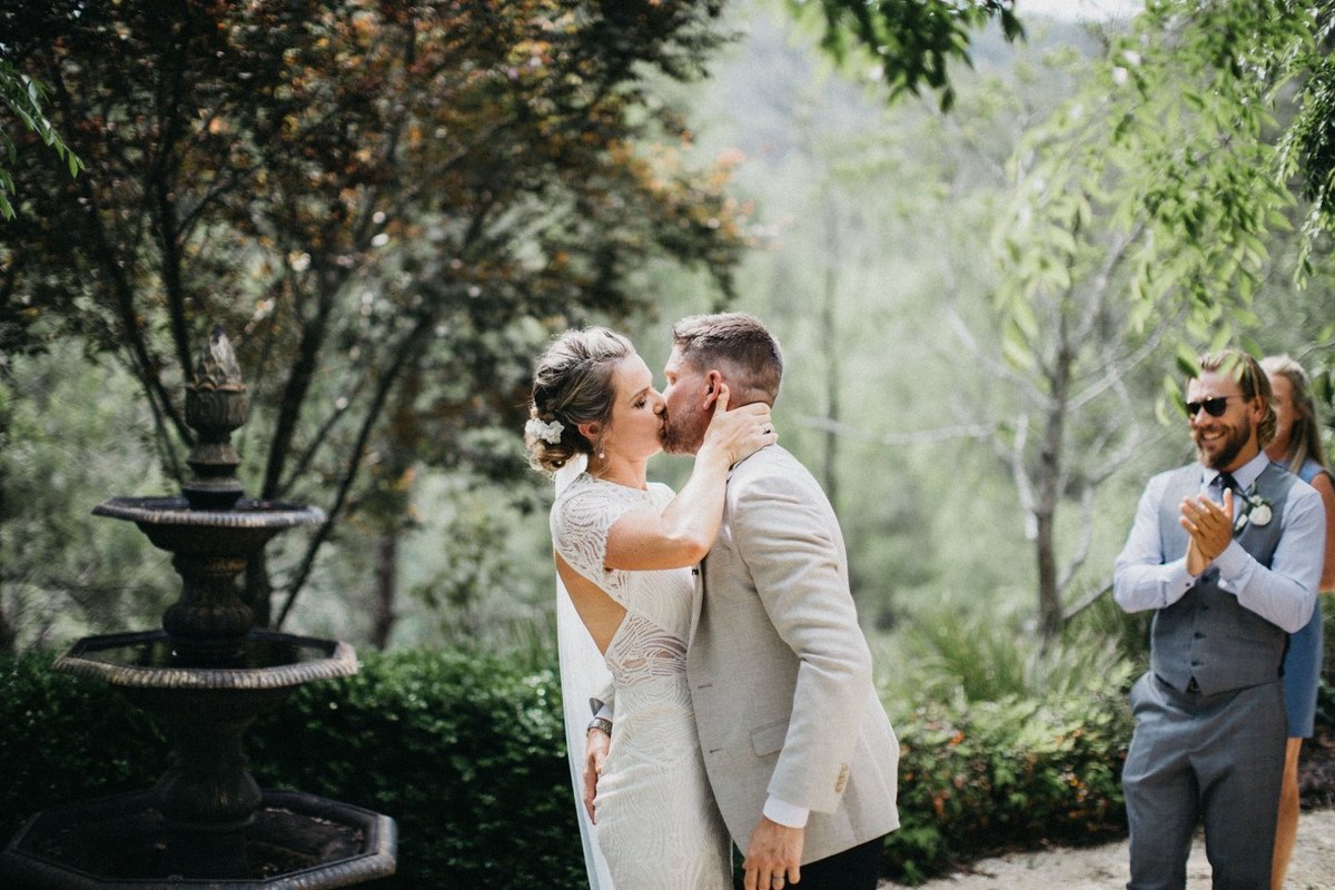 Newlyweds at Redleaf Wollombi — Joshua Mikhaiel, documentary wedding photographer The bride and groom kiss after exchanging vows. Photograph by documentary wedding photographer Joshua Mikhaiel.