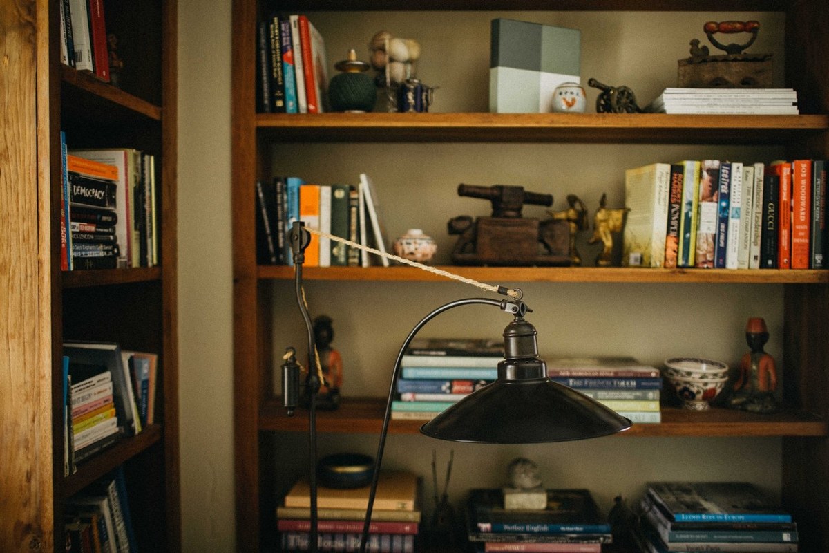 Redleaf Wollombi interior — Joshua Mikhaiel, documentary wedding photographer Books, ornaments and a desk fill a timber bookshelf. Photograph by documentary wedding photographer Joshua Mikhaiel.