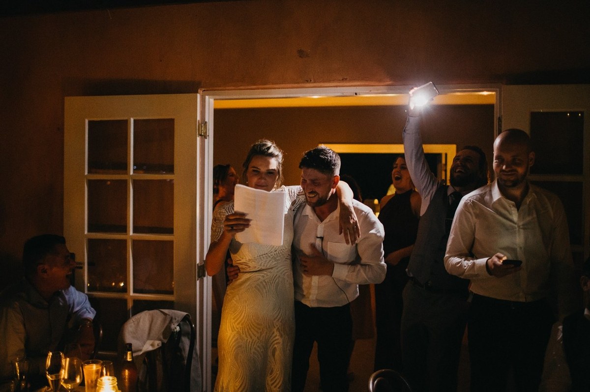 Reception moment at Redleaf Wollombi — Joshua Mikhaiel, documentary wedding photographer A guest holds an illuminated device above the crowd. Photograph by documentary wedding photographer Joshua Mikhaiel.